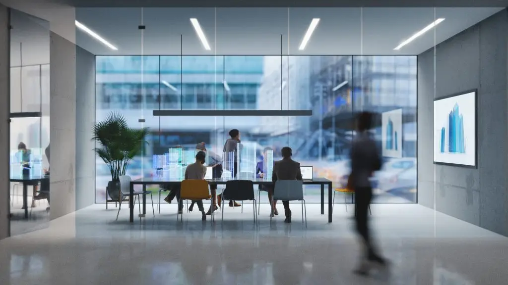 Group of people working in a modern board room.