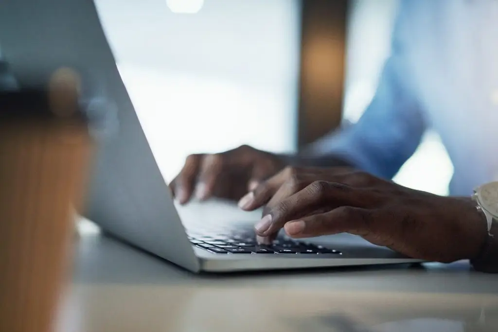 A person typing on a laptop.