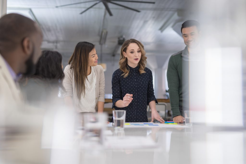 A group of people standing around a table.