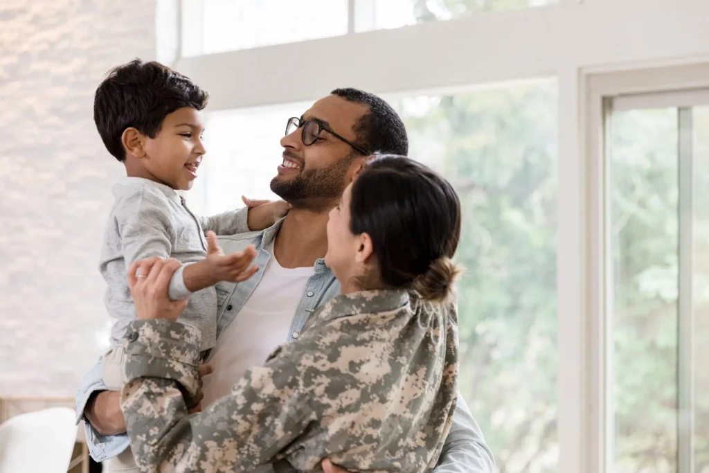 Military woman hugging family