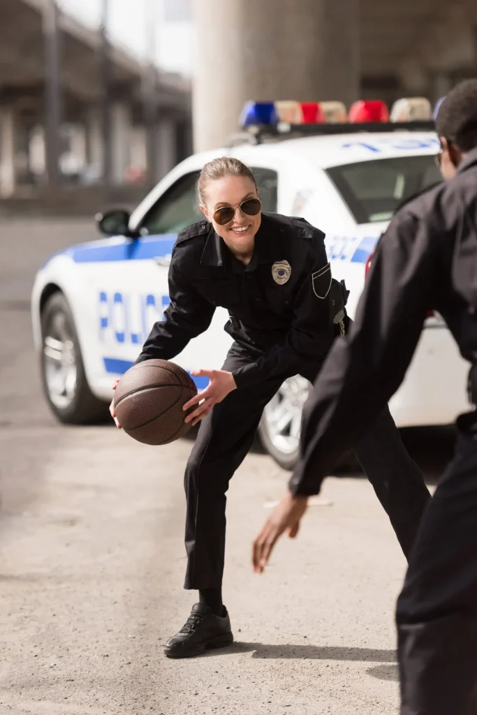 Police officer playing basketball
