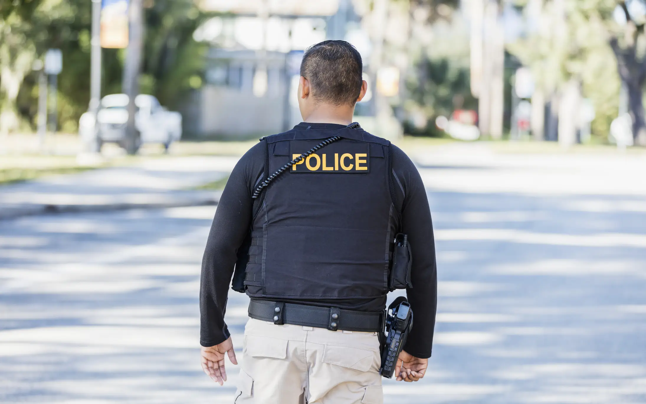 Community policing - rear view of a police officer.
