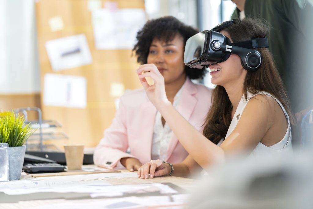 A group of women wearing virtual reality headsets in an office.