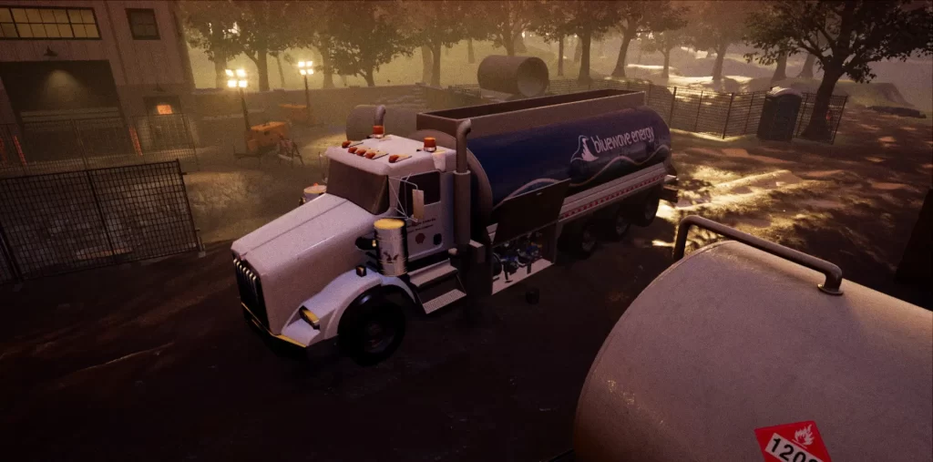 A fuel truck with the Blueploro logo on its side is parked in a dimly lit industrial area with trees and fences. The area appears wet, possibly after rainfall.