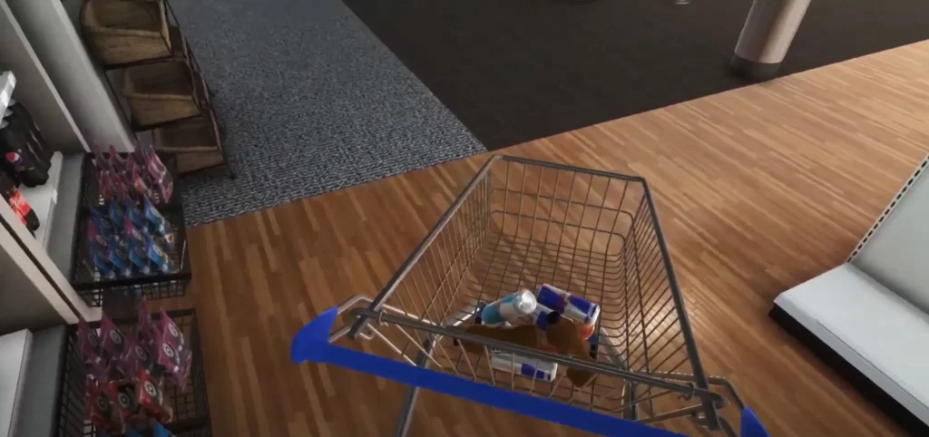 A shopping cart with several items inside is positioned on a store floor, showing a transition from wooden to carpeted flooring. Shelves with merchandise are visible on the side.