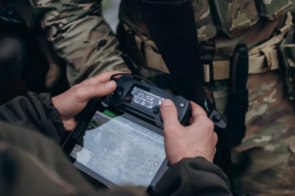 Un groupe de militaires utilisant une tablette pour faire fonctionner le drone