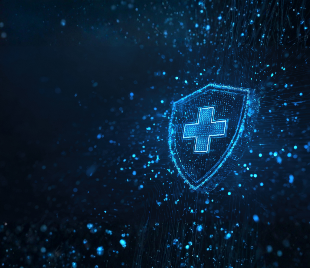 A digital shield icon with a medical cross symbol is surrounded by glowing particles on a dark blue background, representing cybersecurity in healthcare.