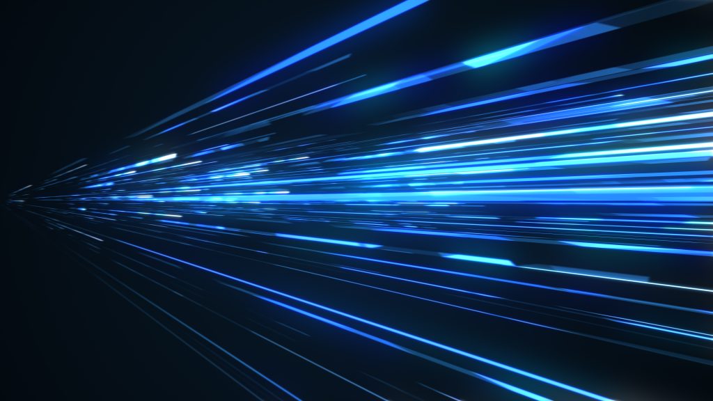 Abstract image of blue light streaks zooming through a dark background, creating a sense of high speed and futuristic motion.