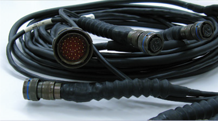 A bundle of black coiled cables with multiple circular connectors, featuring metal and rubber elements.