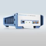 A rectangular electronic device with blue sides and a white front panel labeled "ROHDE & SCHWARZ SFD – DOCSIS® Signal Generator" featuring various ports and connectors.