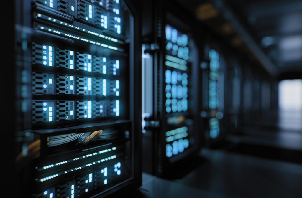 A row of servers in a dark room.