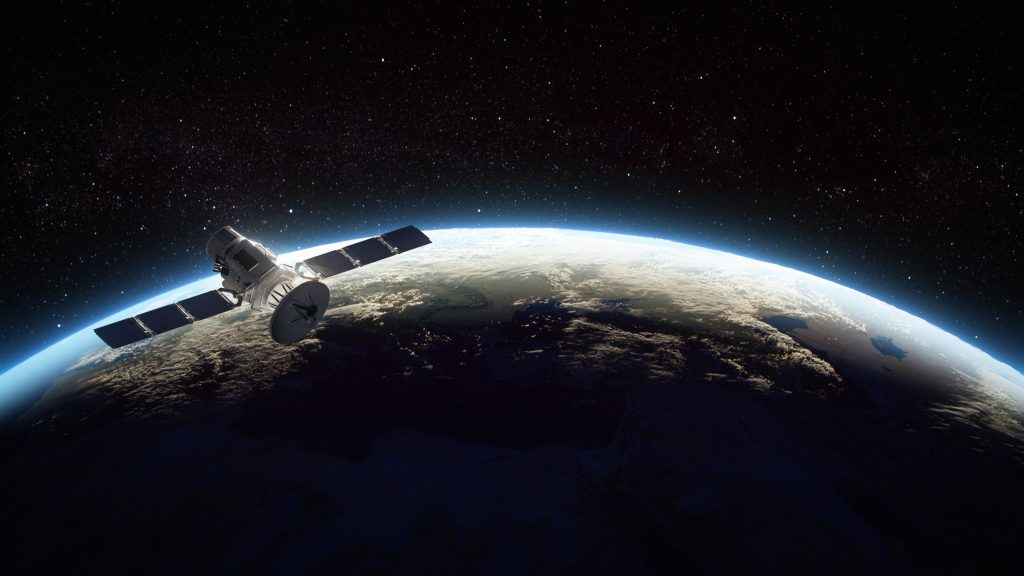A satellite orbiting Earth with a view of the planet's surface and the vast expanse of space in the background.