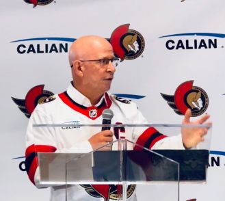 Kevin Ford, Calian CEO, wearing the Calian-sponsored road jersey for the Ottawa Senators hockey team.